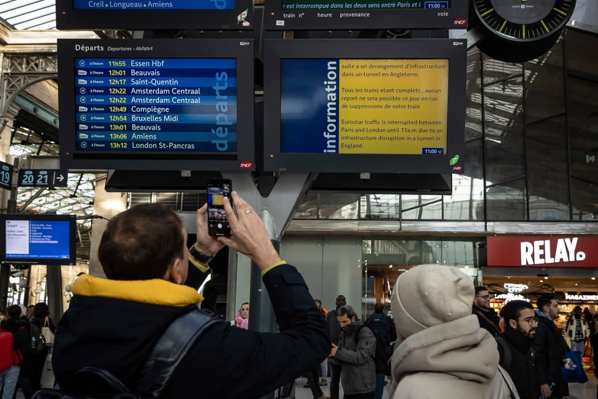Passengers stare at a board of cancellations at the Gare du Nord (AP)