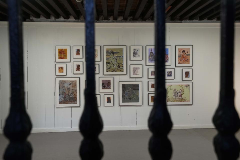 An installation by artist Claire Tabouret is displayed inside the women's prison of he Giudecca island during the 60th Biennale of Arts exhibition in Venice, Italy, Wednesday, April 17, 2024. A pair of nude feet dirty, wounded and vulnerable are painted on the façade of the Venice women's prison chapel, the work of Italian artist Maurizio Cattelan and part of the Vatican's pavilion at the Venice Biennale in an innovative collaboration between inmates and artists. (AP Photo/Luca Bruno)