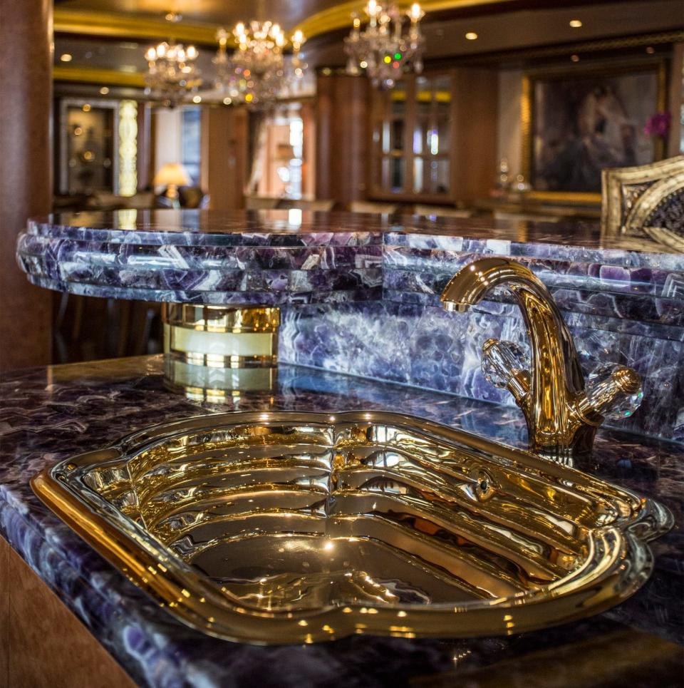 Gold taps and a sink sit in the bar area aboard luxury superyacht Solandge - Bloomberg