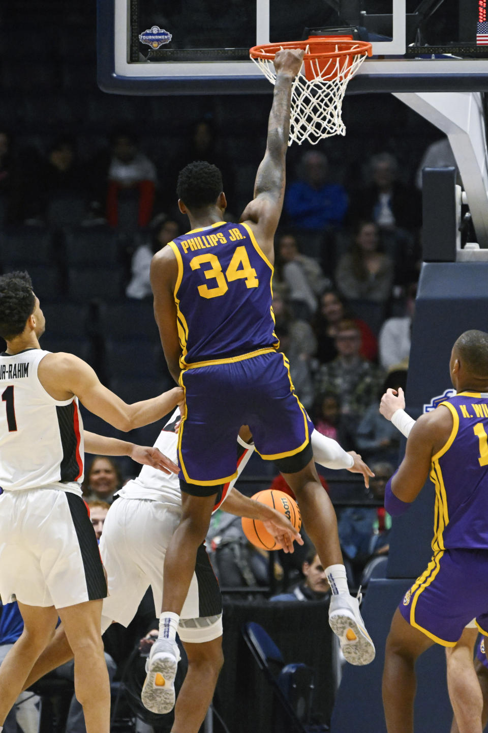 LSU forward Shawn Phillips (34) dunks to go ahead against Georgia in the final minutes of an NCAA college basketball game in the first round of the Southeastern Conference tournament, Wednesday, March 8, 2023, in Nashville, Tenn. LSU won 72-67. (AP Photo/John Amis)