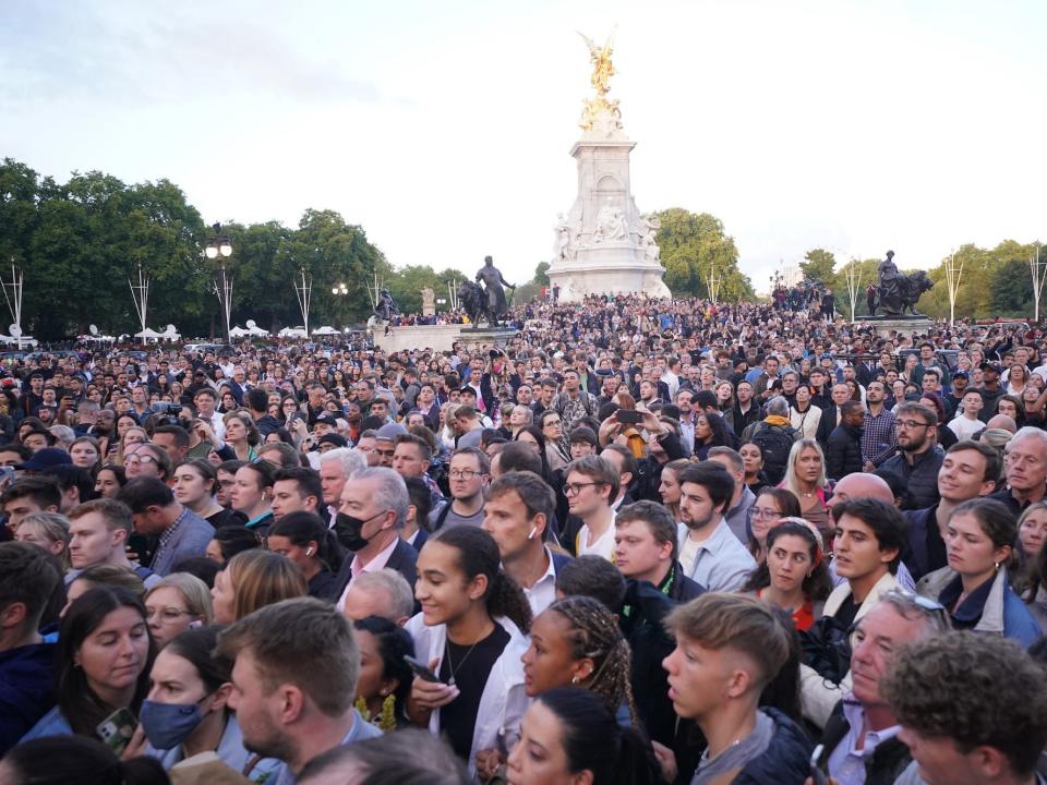 A crowd gathers at Buckingham Palace following Queen Elizabeth II's death.