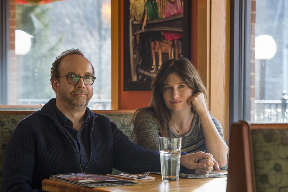 This image released by Netflix shows Paul Giamatti, left, and Kathryn Hahn in a scene from "Private Life." (Jojo Whilden/Netflix via AP)