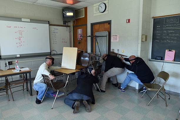 “Students” barricade a door of a classroom to block an “active shooter” during ALICE (Alert, Lockdown, Inform, Counter and Evacuate) training at the Harry S. Truman High School in Levittown, Pennsylvania, on Nov. 3, 2015. (Jewel Samad / Getty Images)