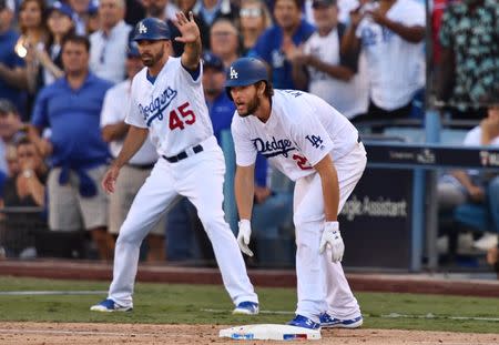 Oct 17, 2018; Los Angeles, CA, USA; Los Angeles Dodgers starting pitcher Clayton Kershaw (22) reacts on third base after center fielder Cody Bellinger (35) hit a single in the seventh inning in game five of the 2018 NLCS playoff baseball series at Dodger Stadium. Mandatory Credit: Robert Hanashiro-USA TODAY Sports