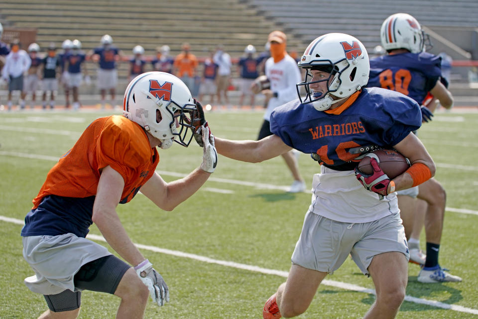 Midland University NAIA college football players practice in Fremont, Neb., Tuesday, Aug. 25, 2020. Midland University is among five small colleges in the state that are pushing forward with plans to play football this fall. The Nebraska Cornhuskers, meanwhile, won't play after Big Ten presidents voted to move back football season until after Jan. 1. (AP Photo/Nati Harnik)