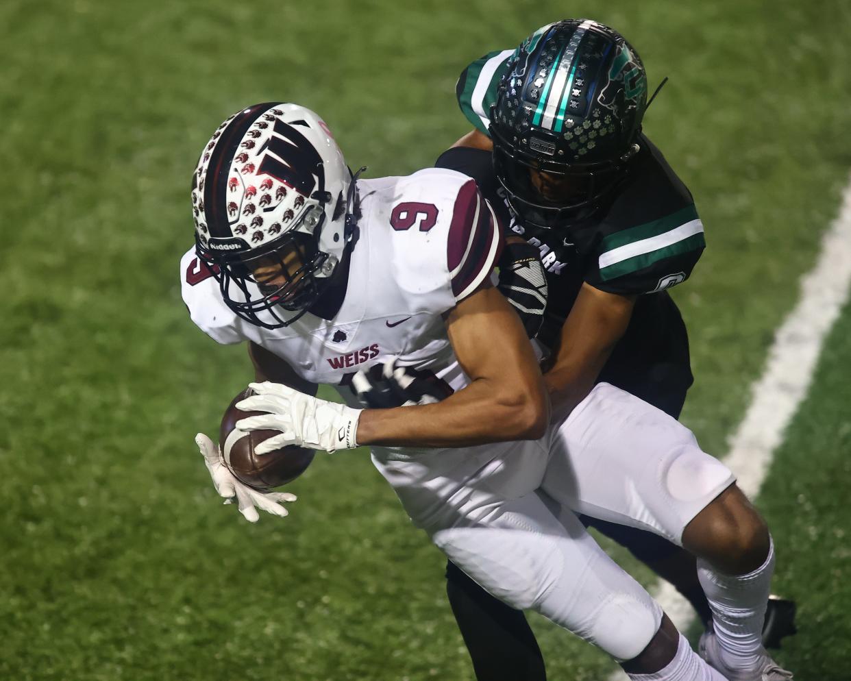 Weiss receiver Micah Gifford, hanging on for a catch against Cedar Park in October, will continue his football career with the Baylor Bears. He was one of dozens of Central Texas-area athletes who signed to play collegiately in multiple sports so far this school year.