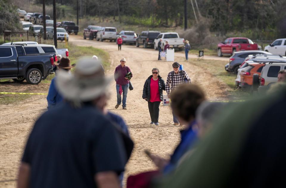 Just below Sugarloaf Mountain, people gather for a ceremony on an old bridge that crosses the Little River.