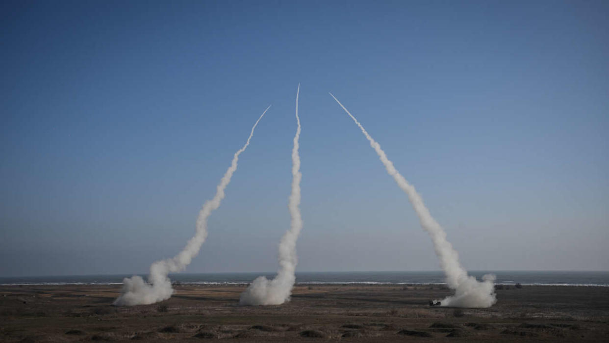 Three Romanian army HIMARS (High Mobility Artillery Rocket System)  fire rockets during 