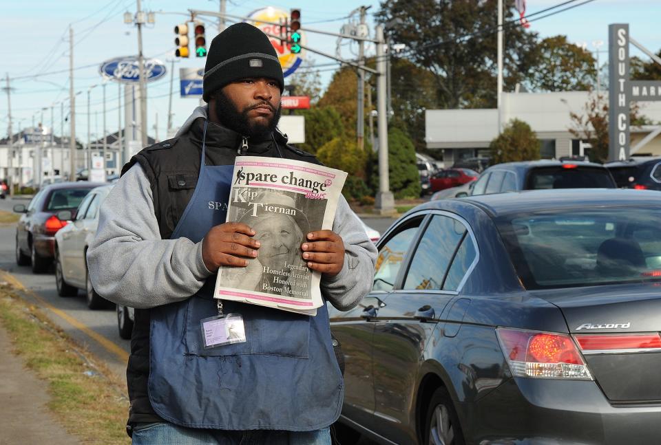 Rama Burch sells copies of the publication "Spare Change" near the entrance to South Coast Marketplace in 2018.