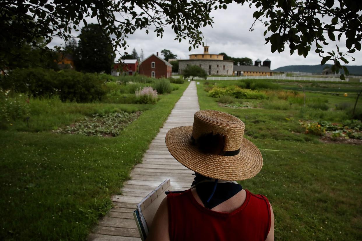 Artist Brece Honeycutt walks to her Artists at Work space at Hancock Shaker Village in Hancock, MA