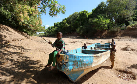 FILE PHOTO: Children play on an abandoned boat along the Shabelle River bed, which is dry due to drought in Somalia's Shabelle region, March 19, 2016. REUTERS/Feisal Omar/File Photo