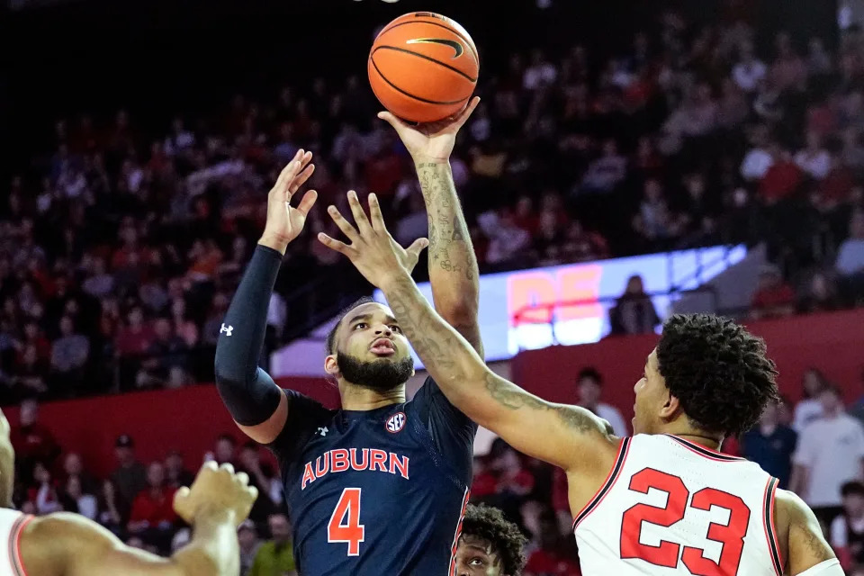 Auburn forward Johni Broome (4) shoots over Georgia center Braelen Bridges (23) during the first half of an NCAA college basketball game Wednesday, Jan. 4, 2023, in Athens, Ga. (AP Photo/John Bazemore)