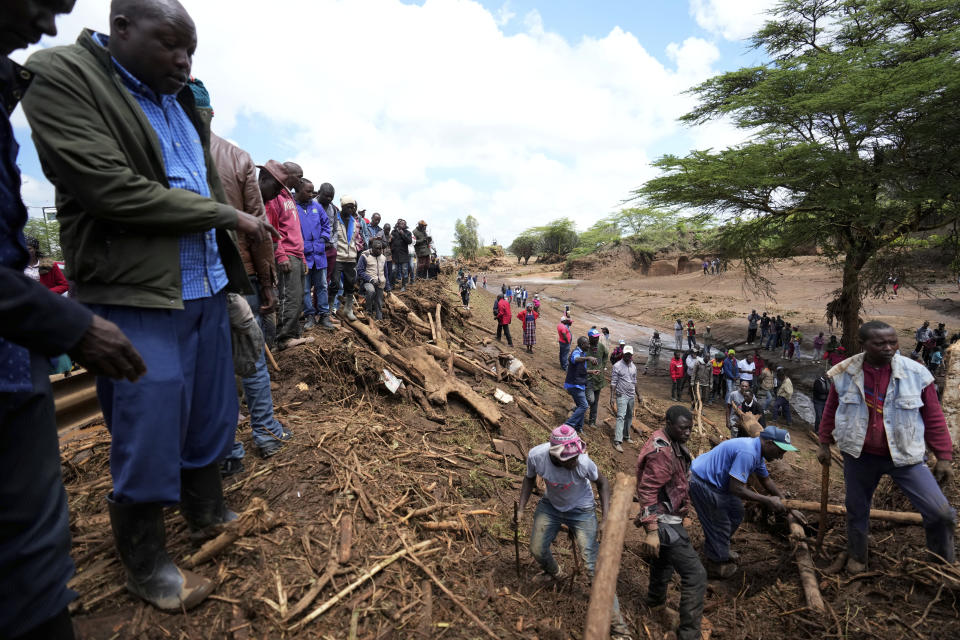 Rescuers search for bodies at a bridge where a woman's body was retrieved, after floodwater washed away houses, in Kamuchiri Village Mai Mahiu, Nakuru County, Kenya, Tuesday, April 30, 2024. Kenya, along with other parts of East Africa, has been overwhelmed by flooding that killed 66 people on Monday alone and in recent days has blocked a national highway, swamped the main airport and swept a bus off a bridge. More than 150,000 people are displaced and living in dozens of camps. (AP Photo/Brian Inganga)