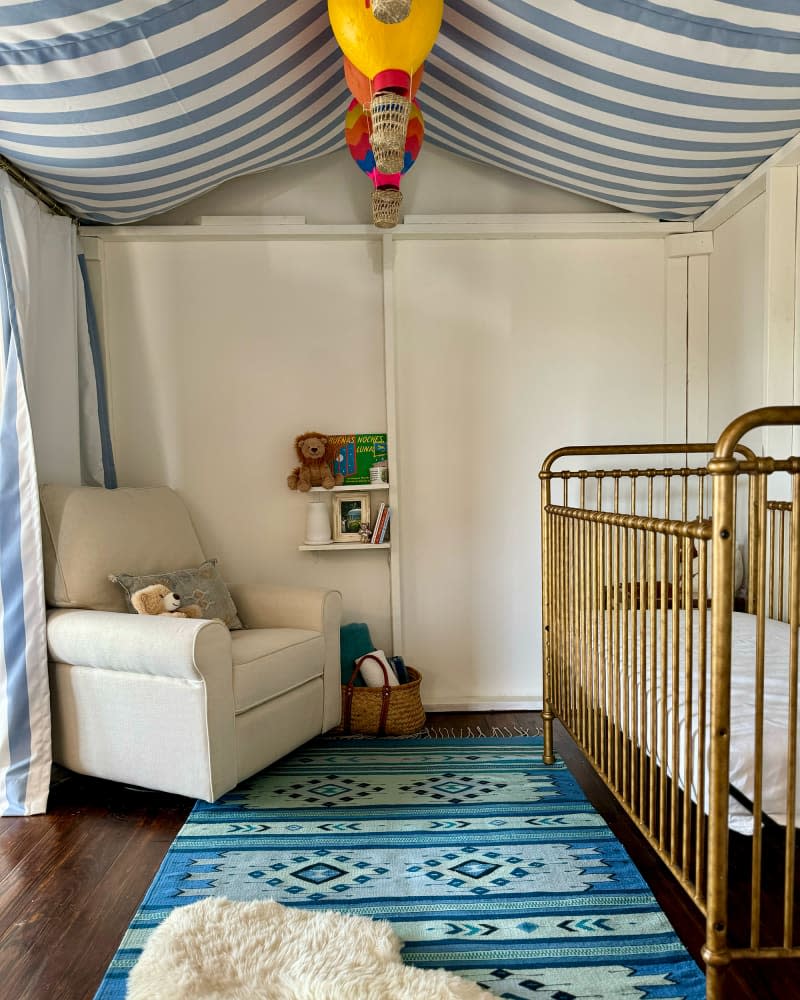 Brass crib in circus themed nursery.