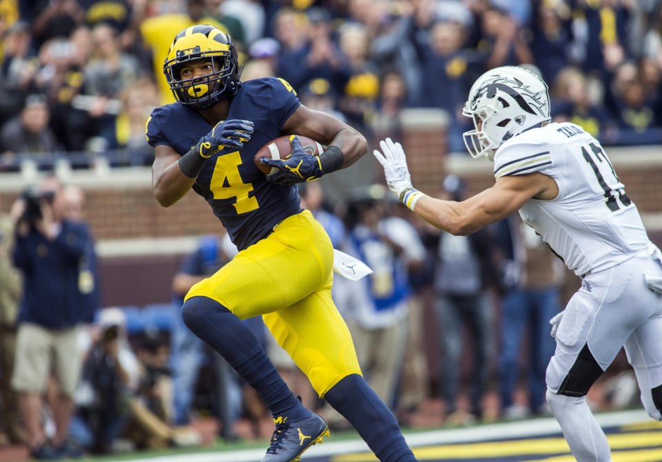 Michigan wide receiver Nico Collins (4) makes a 44-yard touchdown reception as Western Michigan defensive back Harrison Taylor (13) closes in during the second quarter of an NCAA college football game in Ann Arbor, Mich., Saturday, Sept. 8, 2018. (AP Photo/Tony Ding)