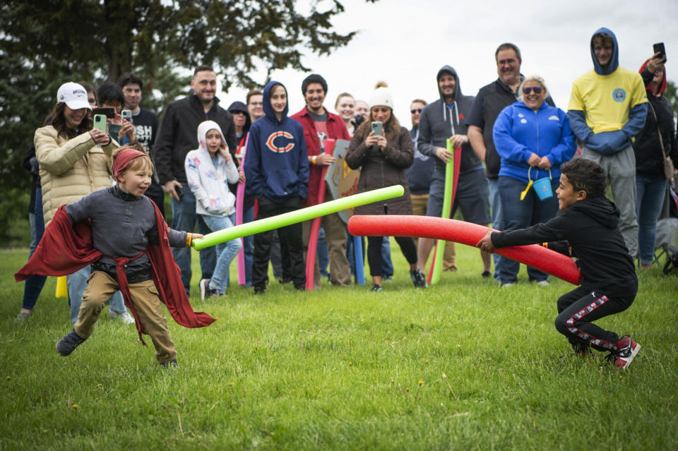 Joshua Memphis Folmar, 4, left, battles reigning champion Josh Vinson Jr., 5, during the second annual Josh Fight at Bowling Lake Park, in Lincoln, Neb., Saturday, May 21, 2022. For the second time in Lincoln's history, Joshes from far and wide gathered to defend the right to their name. Non-Joshes also joined the brawl, and together, the crowd contributed to the $20,576 raised for Children's Hospital Medical Center in Omaha. (Jaiden Tripi/Lincoln Journal Star via AP)