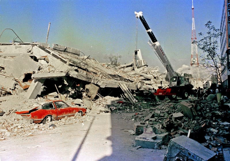 A car sits under rubble after the 1985 Mexico City earthquake