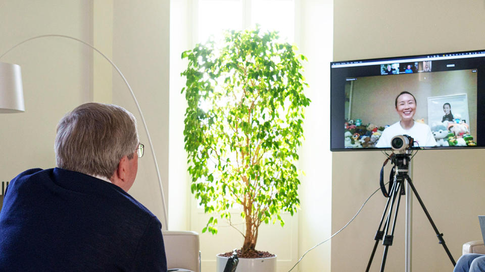 IOC President Thomas Bach holding a video call with Chinese tennis star Peng Shuai. (Image: AAP)