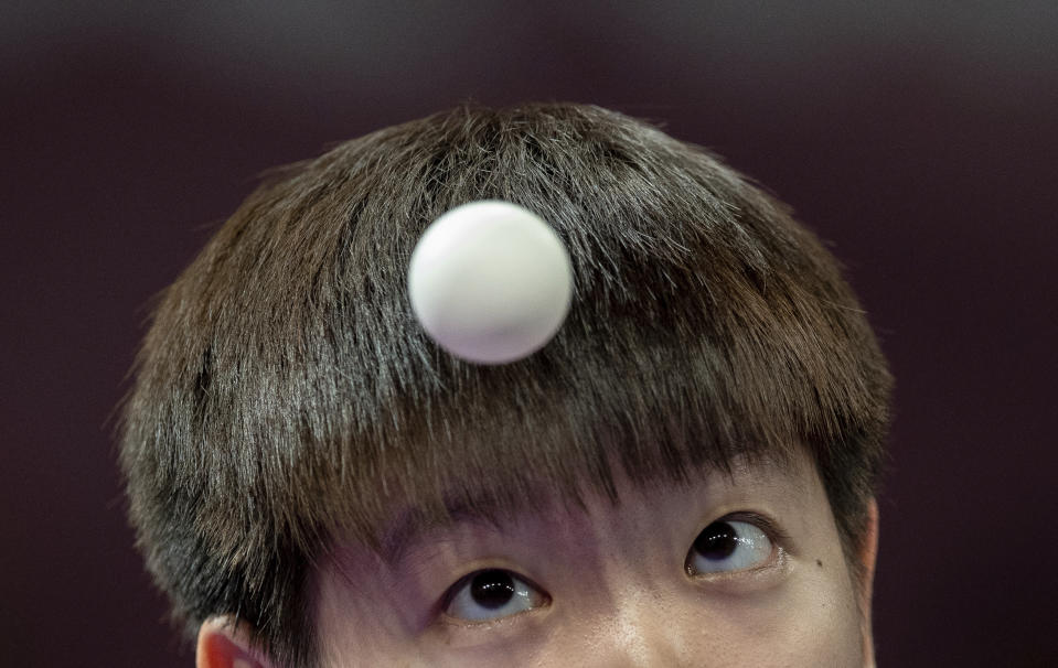 In this Oct. 15, 2018 photo provided by the OIS/IOC, paddler Yingsha Sun of China eyes a ball in the Mixed International Team Semifinal 2 at the Table Tennis Arena in Tecnopolis Park. during the Youth Olympic Summer Games in Buenos Aires, Argentina. (Lukas Schulze/OIS/IOC via AP)