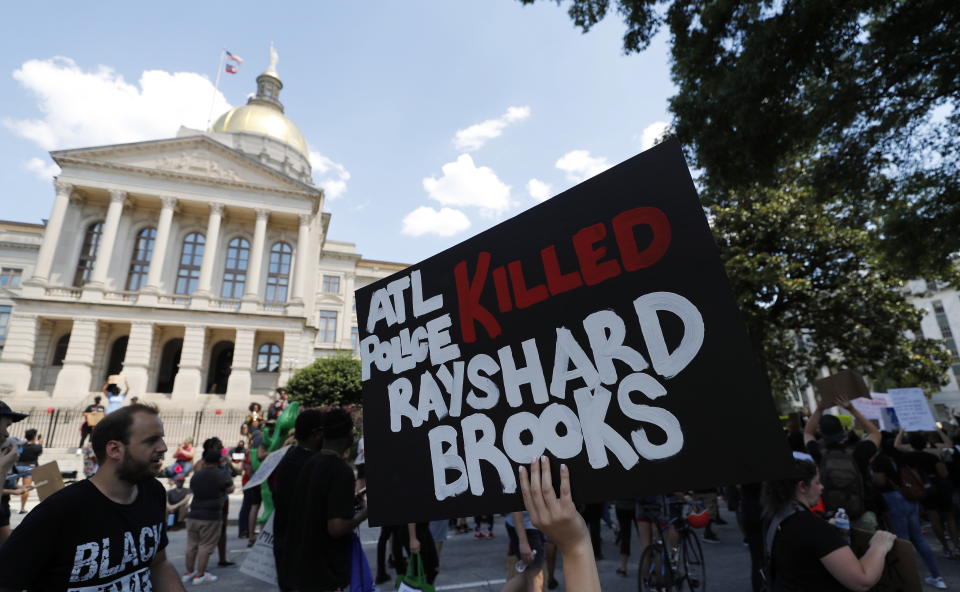 Protesters march near the Georgia Capitol after an Atlanta Police Department officer was involved shooting which left a black man, Rayshard Brooks, 27, dead.  Source: EPA