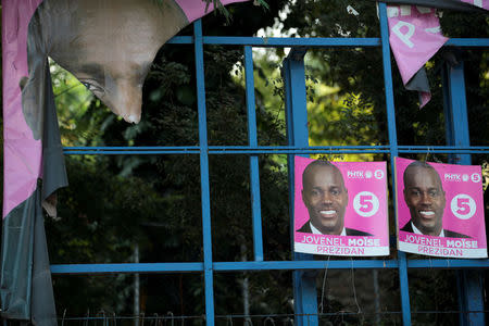 Electoral posters of presidential candidate Jovenel Moise of PHTK (Bald Head Haitian Party), hang on a ripped billboard along a street of Port-au-Prince, Haiti, November 16, 2016. REUTERS/Andres Martinez Casares