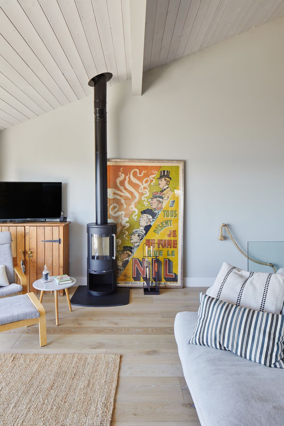 open plan living room with wooden floors and sofa in soft grey