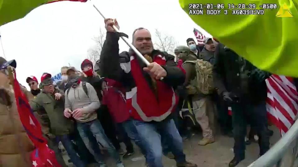 This still frame from Metropolitan Police Department body worn camera video shows Thomas Webster, in red jacket, at a barricade line at on the west front of the U.S. Capitol on Jan. 6, 2021, (AP)