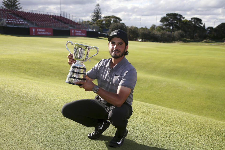 Abraham Ancer of Mexico holds his trophy after winning the Australian Open Golf tournament in Sydney, Sunday, Nov. 18, 2018. (AP Photo/Rick Rycroft)