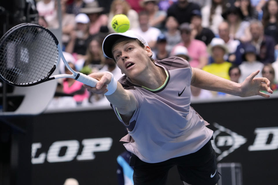 Jannik Sinner of Italy plays a backhand return to Sebastian Baez of Argentina during their third round match at the Australian Open tennis championships at Melbourne Park, Melbourne, Australia, Friday, Jan. 19, 2024. (AP Photo/Andy Wong)