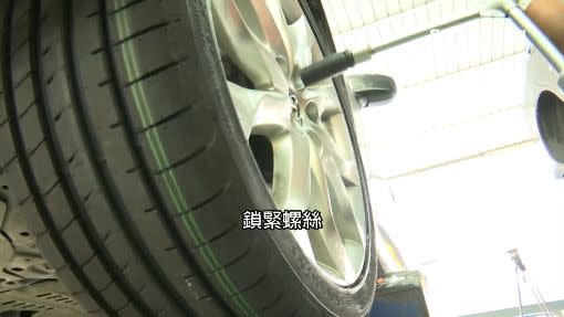 技師更換汽車輪胎。