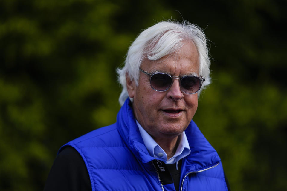 Bob Baffert, center, owner of Preakness Stakes entrant National Treasure, walks near the stables ahead of the 148th running of the Preakness Stakes horse race at Pimlico Race Course, Friday, May 19, 2023, in Baltimore. (AP Photo/Julio Cortez)