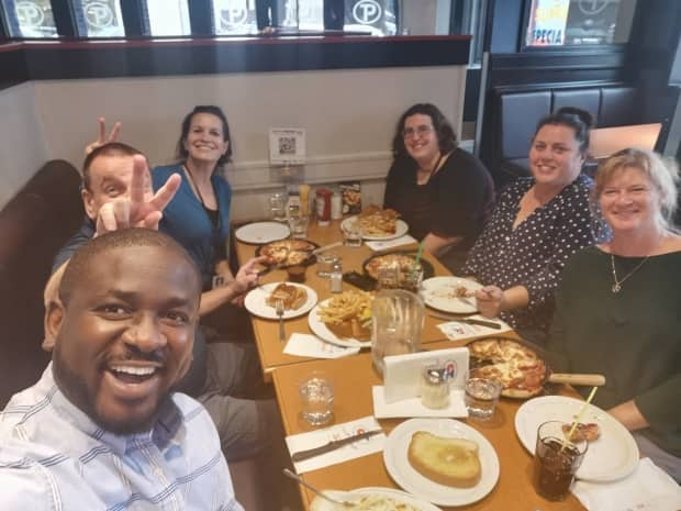 Michael Ifeanyi and his colleagues grabbing a meal together.