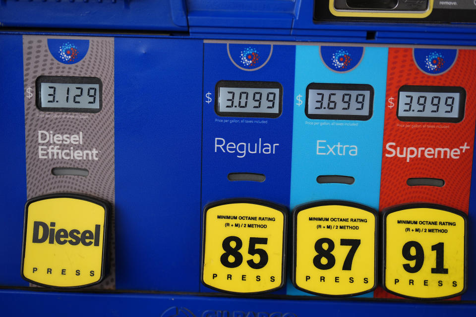 The per-gallon price is displayed electronically above the grades of gasoline available from a pump at an Exxon station Wednesday, Sept. 4, 2024, in Littleton, Colo. (AP Photo/David Zalubowski)