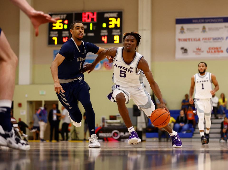 Kansas State guard Cam Carter (5) drives to the basket against Nevada's Tyler Powell (1) during last year's Cayman Islands Classic. Wildcats coach Jerome Tang is looking for big scoring numbers from Carter this season.