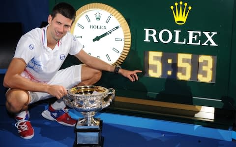 Novak Djokovic...Serbia's Novak Djokovic poses for a photo of a clock showing the match time of his final against Spain's Rafael Nadal during the men's singles final at the Australian Open tennis championship, in Melbourne, Australia, early Monday, Jan. 30, 2012 - Credit: AP