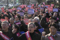 Doctors stage a rally against the government's medical policy near the presidential office in Seoul, South Korea, Sunday, Feb. 25, 2024. The South Korean government on Wednesday warned thousands of striking doctors to return to work immediately or face legal action after their collective walkouts caused cancellations of surgeries and disrupted other hospital operations. (AP Photo/Ahn Young-joon)