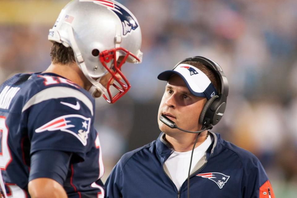 Aug 28, 2015; Charlotte, NC, USA; New England Patriots quarterback Tom Brady (12) talks with offensive coordinator Josh McDaniels during the second quarter against the Carolina Panthers at Bank of America Stadium. Mandatory Credit: Jeremy Brevard-USA TODAY Sports