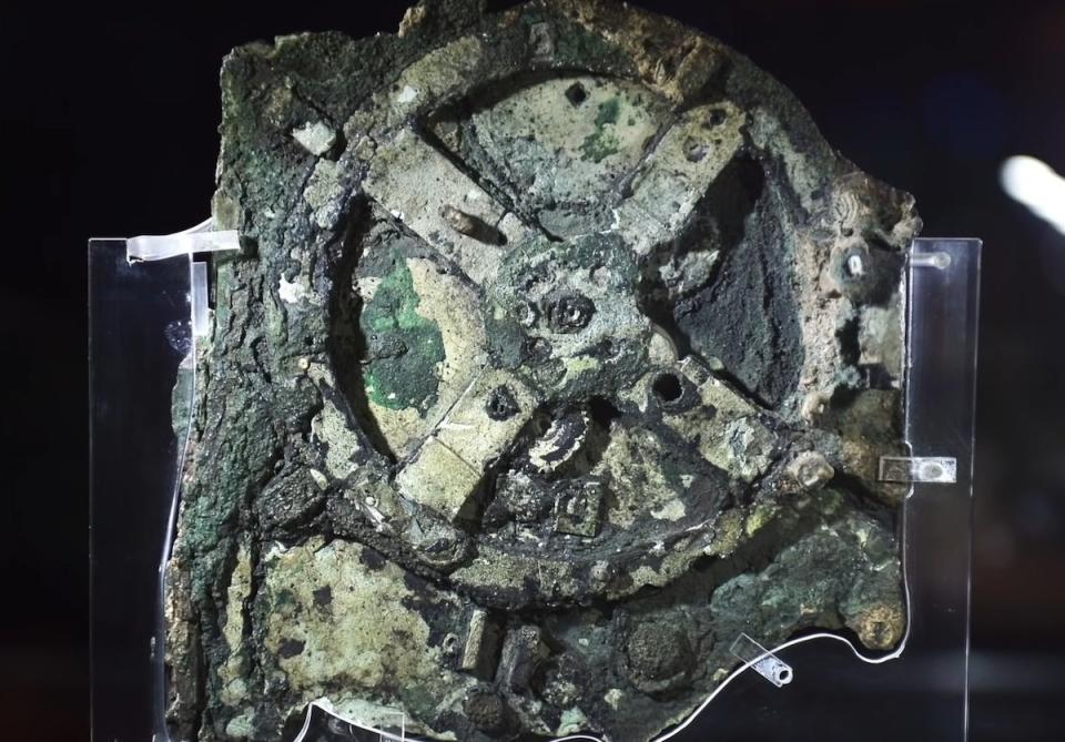 An old bronze machine worn away and grayed by water known as the Antikythera mechanism