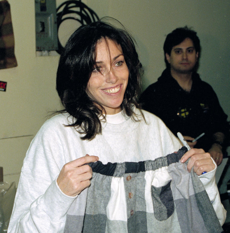 FILE - Heidi Fleiss, holds a pair of shorts from her clothing line, named Heidi Wear, in Los Angeles, Calif., in this Dec. 3, 1994 file photo. The woman dubbed the "Hollywood Madam" when she was accused in the mid-1990s of running a high-priced Los Angeles prostitution ring says she's moving out of the southern Nevada town where she's lived for about 15 years. (AP Photo/Michael Tweed, File)