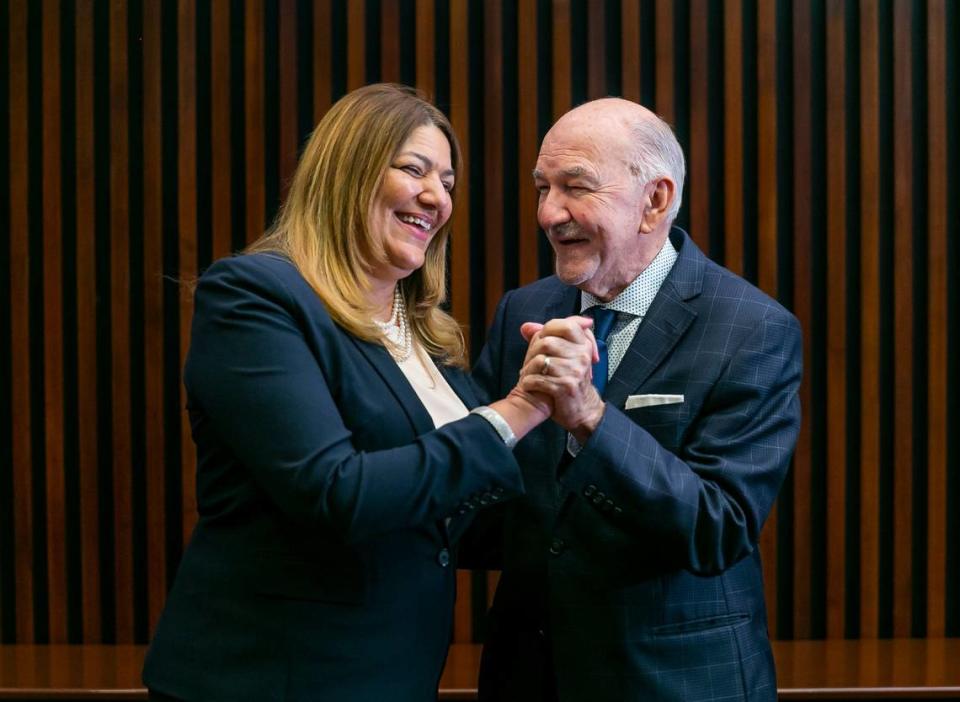 Madeline Pumariega, the president of Miami Dade College, and her father, Miguel Pumariega, 84, hold hands near her office at the Wolfson Campus in downtown Miami, Florida on Tuesday, November 30, 2021. 