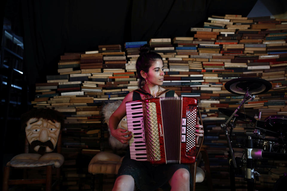 Tamar Lehman, a social counselor for mentally ill young adults, plays an accordion inside a cultural center used by Yung Yidish, a nonprofit group aiming to preserve Yiddish culture, at the Central Bus Station on May 25.  (Photo: Corinna Kern/Reuters)