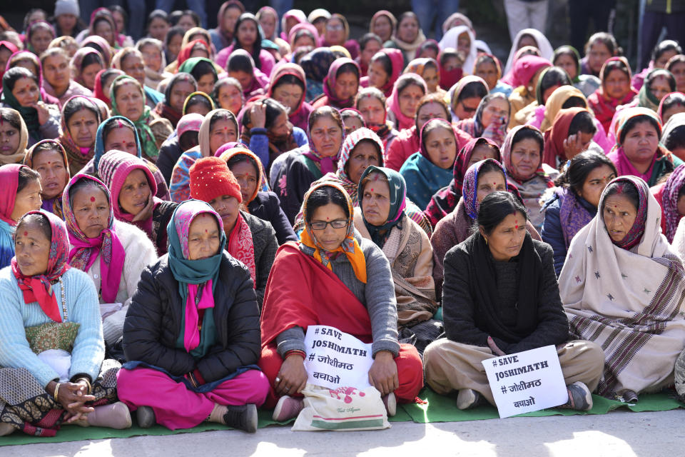 A group of women demanding to save their town, participate in a sit in demonstration in Joshimath, India's Himalayan mountain state of Uttarakhand, Jan. 19, 2023. For months, residents in Joshimath, a holy town burrowed high up in India's Himalayan mountains, have seen their homes slowly sink. They pleaded for help, but it never arrived. In January however, their town made national headlines. Big, deep cracks had emerged in over 860 homes, making them unlivable. (AP Photo/Rajesh Kumar Singh)
