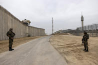 Israeli soldiers secure the site of a ceremony marking the completion of an enhanced security barrier along the Israel-Gaza border, Tuesday, Dec. 7, 2021. Israel has announced the completion of the enhanced security barrier around the Gaza Strip designed to prevent militants from sneaking into the country. (AP Photo/Tsafrir Abayov)