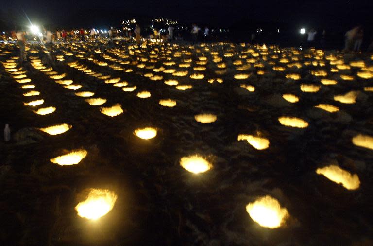 Candles light up Phuket Island's tsunami-hit Patong Beach, 31 January 2005, as hundreds attended a candlelight vigil