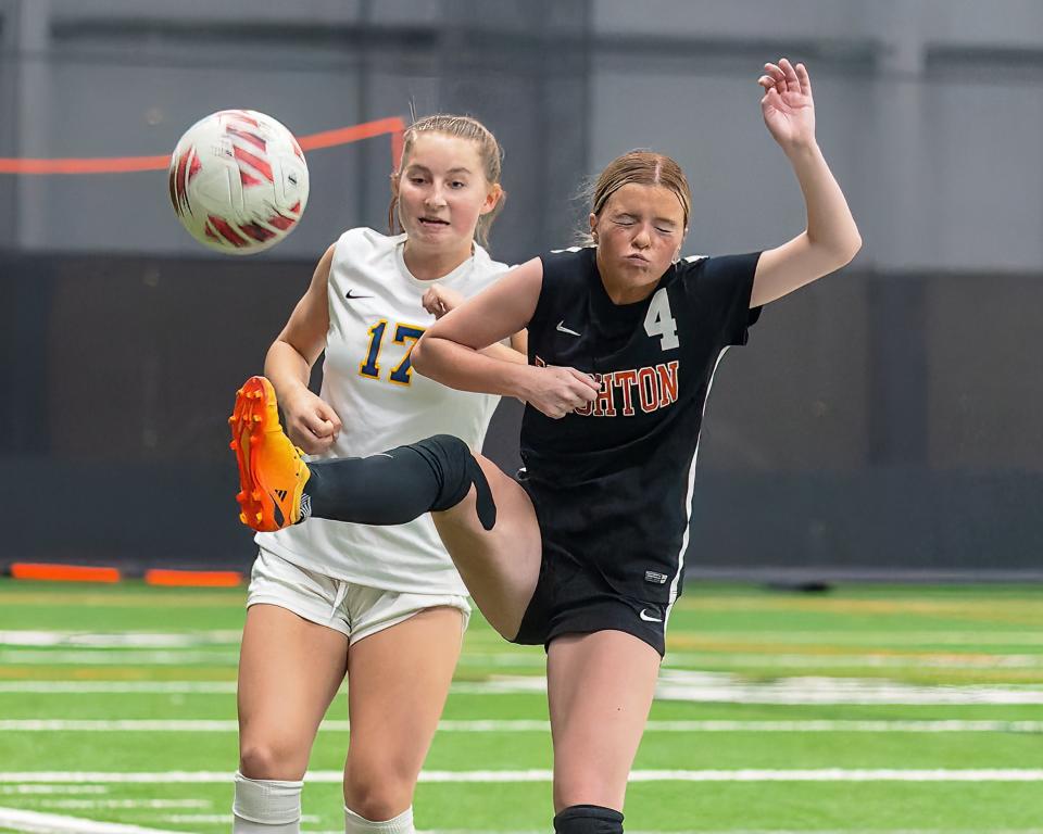 Brighton's Ellla Vandemergel (4) plays the ball in front of Hartland's Sophia Pietila (17), Tuesday 7 May 2024.