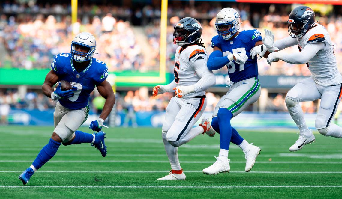 Seattle Seahawks running back Kenneth Walker III (9) runs into the end zone a touchdown that will be called back on a offensive holding call on wide receiver DK Metcalf (14) during the third quarter of the game at Lumen Field, on Sunday, Sept. 8, 2024, in Seattle, Wash.