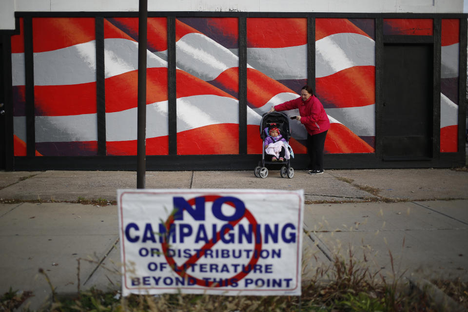 A voter stands with a stroller outside the American Legion Post #469 polling location in Cleveland, Ohio, on Nov. 8.&nbsp;