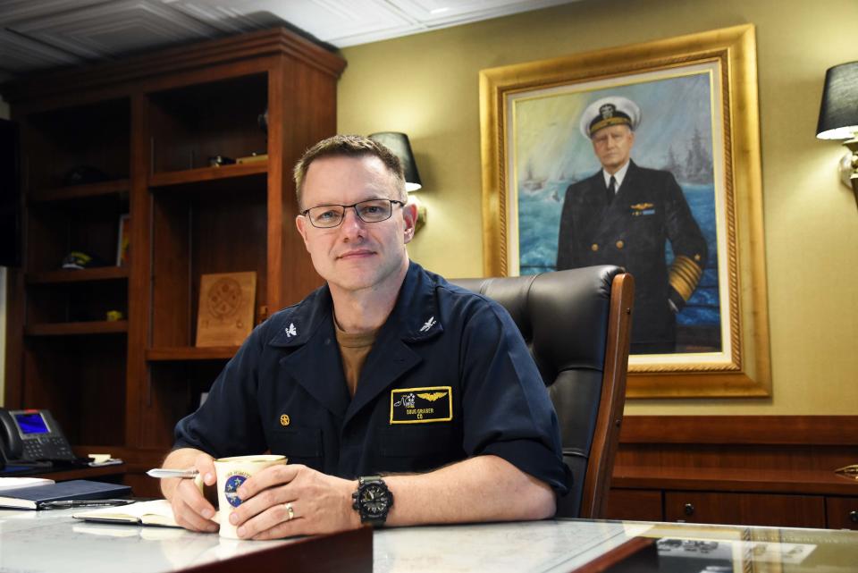 Capt. Douglas Graber sits at his office on the USS Nimitz aircraft carrier on July 1, 2023. Graber relieves Capt. Craig Sicola as commanding officer of the Nimitz on June 29, 2023.