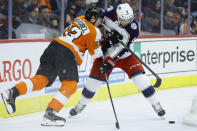 Philadelphia Flyers' Nicolas Aube-Kubel, left, hits Columbus Blue Jackets' Scott Harrington during the second period of an NHL hockey game, Tuesday, Feb. 18, 2020, in Philadelphia. (AP Photo/Matt Slocum)