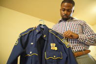 Former Louisiana State Police Trooper Carl Cavalier holds his uniform at his home in Houma, La. on Friday, Oct. 15, 2021. Cavalier, a Black state trooper who was once decorated for valor but recently fired in part for criticizing the agency’s handling of brutality cases, says, “If you’re a part of the good ol’ boy system, there’s no wrong you can do. (AP Photo/Allen G. Breed)